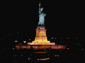 This is the Statue of Liberty lit up at night on Liberty Weekend. It was taken from the Aircraft Carrier Kennedy. © spiritofamerica