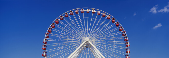 This is an aerial view of the giant Ferris wheel at Navy Pier during summer. It is a view of half...
