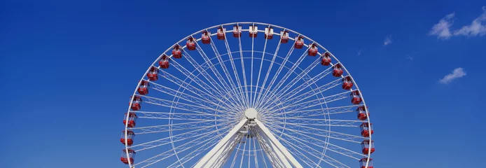 Deurstickers This is an aerial view of the giant Ferris wheel at Navy Pier during summer. It is a view of half the Ferris wheel against a blue sky. © spiritofamerica