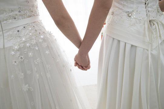 Brides are holding hands