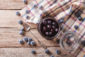 Fresh blueberry marmalade in a glass jar. horizontal top view
