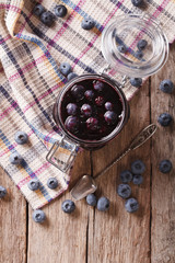 Fresh blueberry marmalade in a glass jar. Vertical top view
