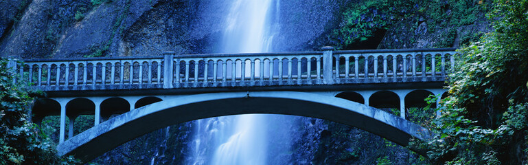 This is a close up of the Multnomah Falls and footbridge. It has a 542 ft. drop from the top.