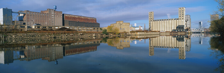 This shows an industrial building through a clearing of trees on the Rogue River.
