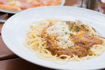 Spaghetti bolognese with parmesan cheese. Selective focus.