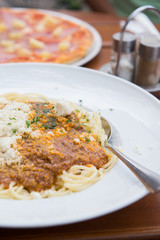 Spaghetti bolognese with parmesan cheese. Selective focus.