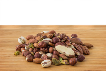 Close-up of mixture of several different peanuts on a wooden table. Copy space.