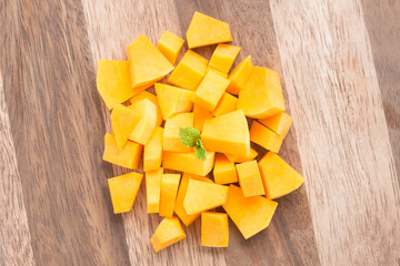 Squash butternut slice on a wood background.