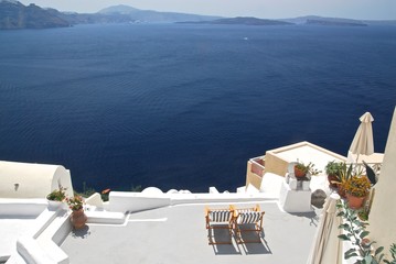 Two chairs on terrace with a stunning seaview on Santorini caldera