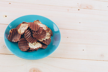 potato chip with chocolate on wood