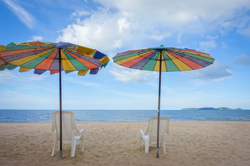 Beach chair and umbrella on sand beach