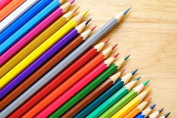 Fototapeta premium Color pencils on wood background