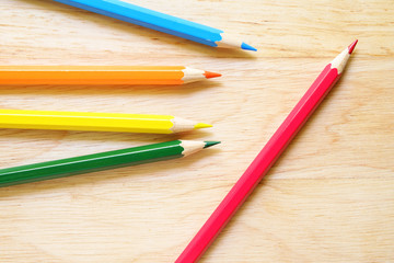 Fototapeta premium Color pencils on wood background