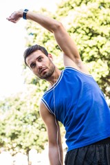 Handsome athlete stretching 