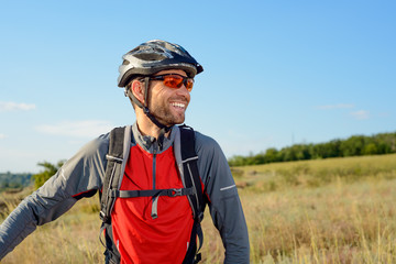 Portrait of Young Cyclist in Helmet and Glasses