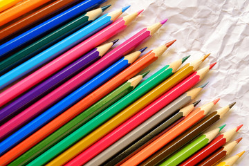 Fototapeta premium Color pencils on Crumpled white paper background