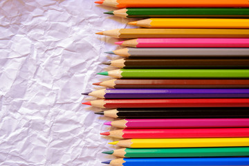 Color pencils on Crumpled white paper background
