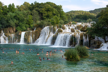 KRKA NATIONAL PARK, CROATIA - AUG 10, 2015: Tourists swim in the