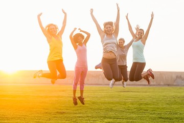 Happy sporty women jumping during fitness class