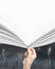 Woman hand pulling blank white  curtain covering stormy city