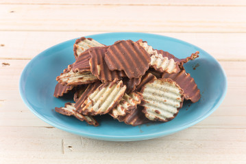 potato chip with chocolate on wood