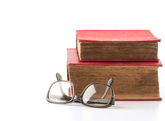 old book with glasses on white background