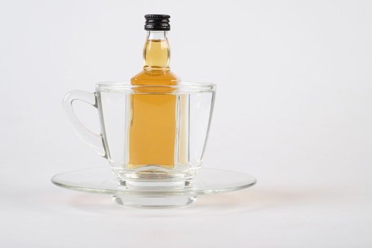 whiskey in cup on white table