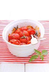 baked cherry tomatoes in a white ceramic form