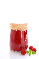 jar with raspberry jam on a white background