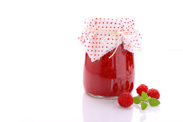 jar with raspberry jam on a white background