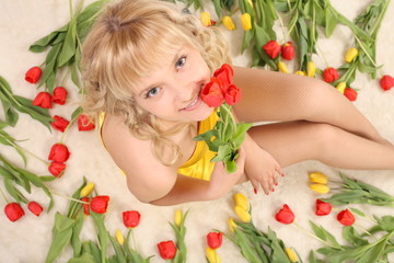 Naklejka na ściany i meble beautiful girl in the tulips