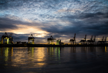 Container Cargo freight ship with working crane loading bridge i