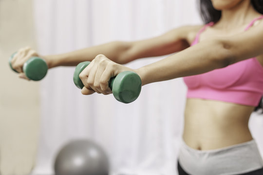 Woman Lifting Small Weights With Both Hands