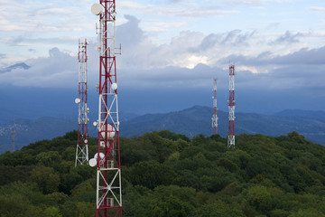Metal structures on the top of high mountain above clouds