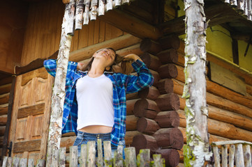 Attractive woman  in the wooden house, relaxed summery atmosphere