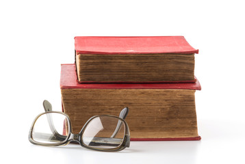 old book with glasses on white background