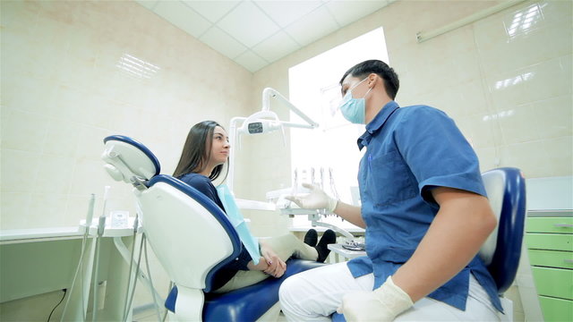 Dentist in the mask says to the patient, then they show a thumbs