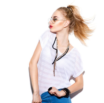 Model girl isolated on white. Blonde woman posing in fashionable clothes and sunglasses