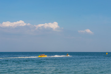 Seascape with Banana boat. Jet ski carries tourists on a banana