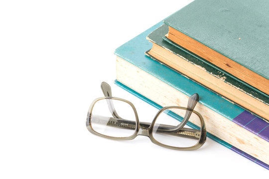 old book with glasses on white background