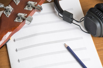 headphone guitar notebook and pencil