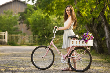 Obraz na płótnie Canvas Happy girl with her bicycle