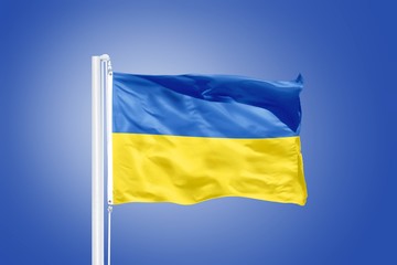 Flag of Ukraine flying against a blue sky
