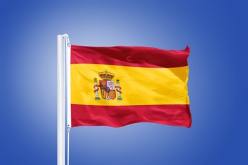 Flag of Spain flying against a blue sky