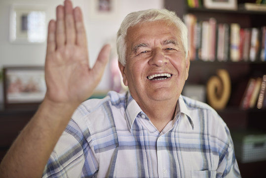 Senior man waving to the camera