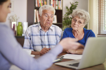 Financial counsellor giving an advice to senior couple