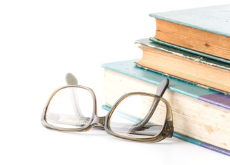 old book with glasses on white background