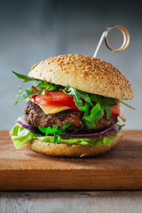 Delicious burgers with beef, tomato, cheese and lettuce
