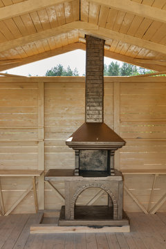 Newly built stone grill in a wooden pavilion