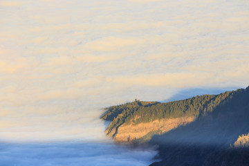 Aerial view over clouds above ocean water with last sunshine, Tenerife, Canary Islands, Spain